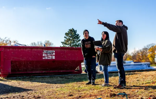 Three team members looking at a construction site