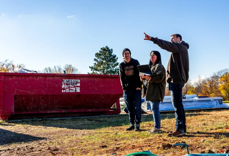 Three team members looking at a construction site
