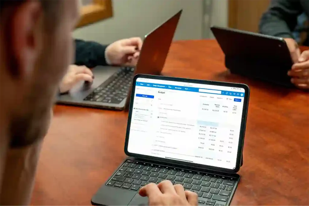 Man looking at Buildertrend budgeting product screen