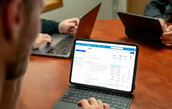 Man looking at Buildertrend budgeting product screen