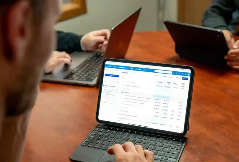 Man looking at Buildertrend budgeting product screen