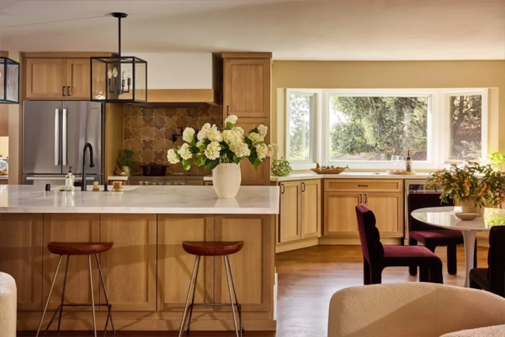 Bright, open-concept kitchen remodel with natural wood cabinetry, a large island, and modern finishes.