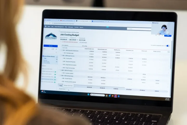 Person viewing a construction job costing budget in Buildertrend during a video call