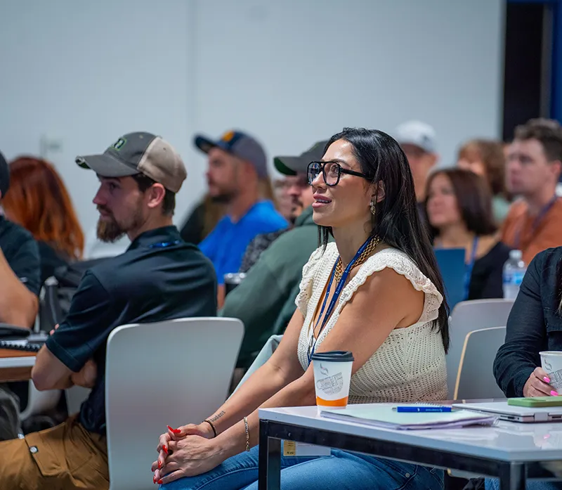 Construction professionals attending a Buildertrend educational session and listening to a presentation.