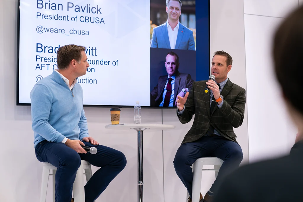 IBS 2027 5 CBUSA President Brian Pavlick and AFT Construction President Brad Leavitt speaking during a panel at the International Builders' Show.