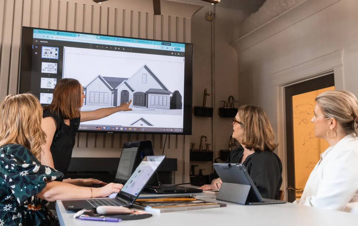 Construction professionals reviewing custom home plans during a project planning meeting.
